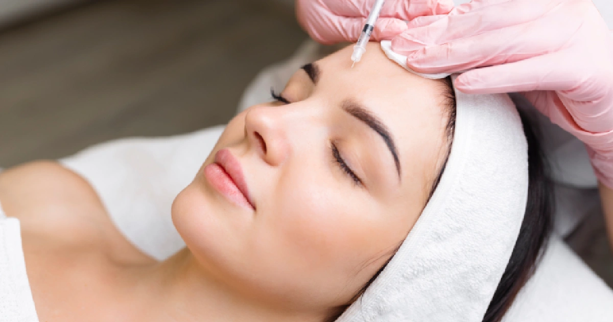 Woman receiving dermal filler injection for facial rejuvenation